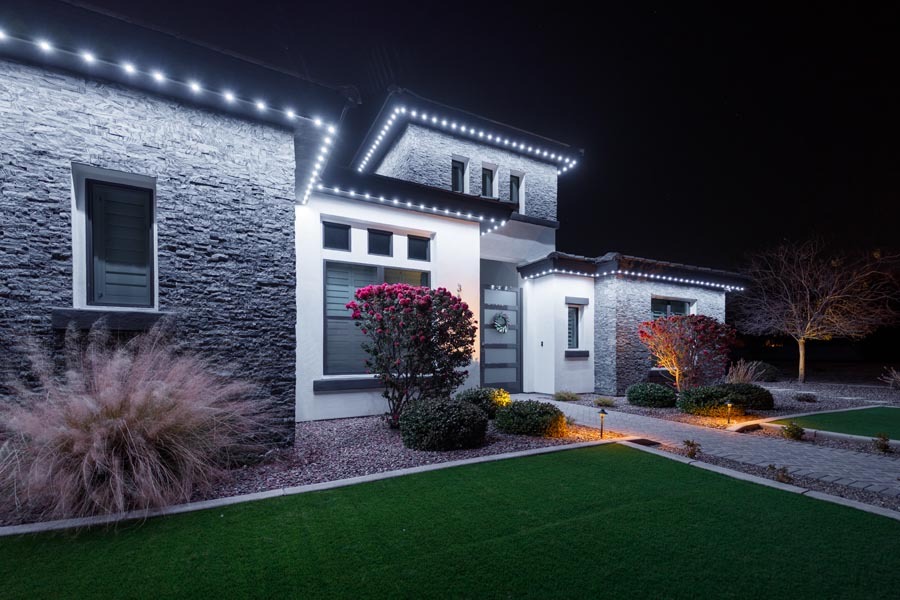 Home with warm white permanent LED lighting across the front elevation